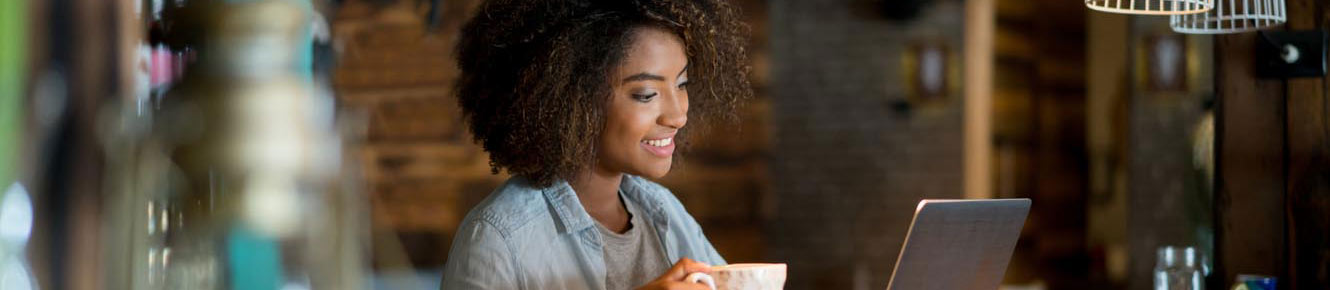 Woman having coffee on laptop