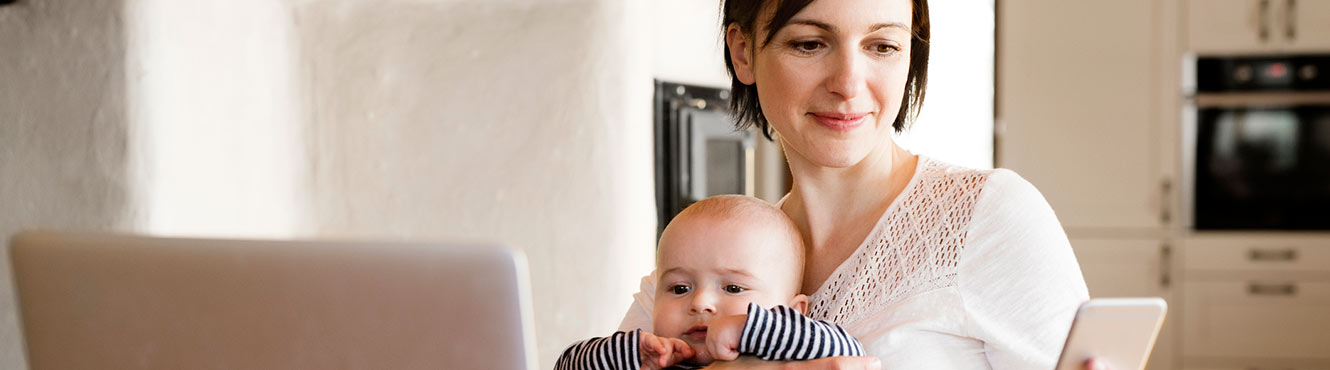 Mom and baby looking at phone.