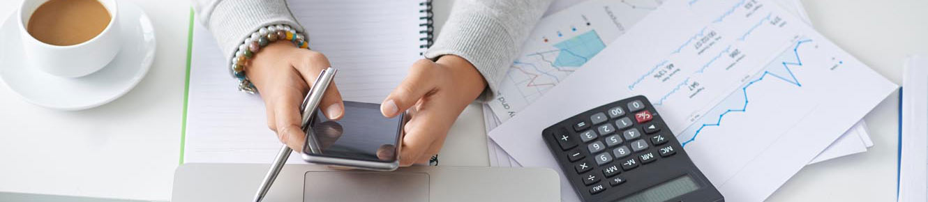 Woman's hands holding phone with calculator.